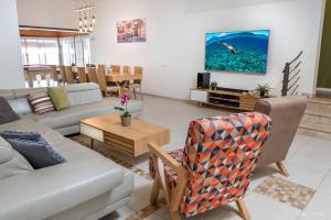 a living room with a couch and a table at SOL Villa Loca in ‘Ein Ya‘aqov