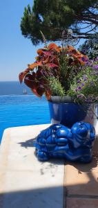 eine blaue Statue eines Blumentopfs mit einer Pflanze in der Unterkunft Al lado del mar "Villa Tortuga 12" in Lloret de Mar
