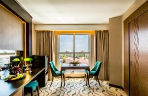 a room with a table and chairs and a window at Lozengrad Hotel in Kırklareli