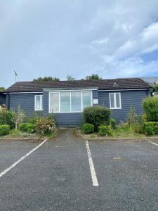 a house with a parking lot in front of it at Ty Bach in Aberystwyth