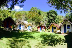 a row of cottages in a field of grass at "Brilho do Sol" in Lumiar