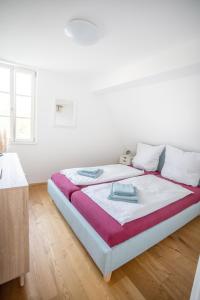 a white bedroom with a large bed in a room at Anni`s Inn in Bruchsal