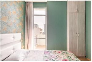 a bedroom with a bed and a window at 1BR Cozy apartment in Batumi