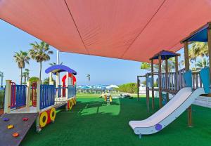a playground with a slide in a park at Leonardo Cypria Bay in Paphos