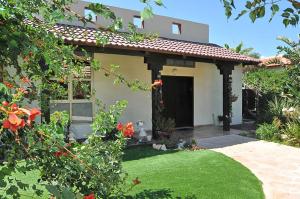 a small house with a lawn in front of it at SOL Villa Loca in ‘Ein Ya‘aqov