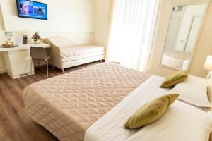 Postel nebo postele na pokoji v ubytování Hotel Corso