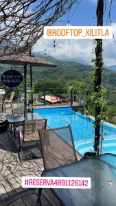 a resort with a pool and a table and chairs at ROOF TOP Hotel XILITLA in Xilitla