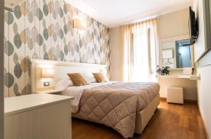 Postel nebo postele na pokoji v ubytování Hotel Corso