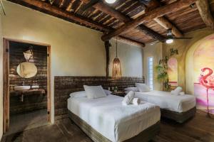 Postel nebo postele na pokoji v ubytování Hidden Treehouse Tulum Eco-Hotel