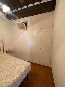 a bedroom with a bed and a white closet at Casa marciana alta in Marciana