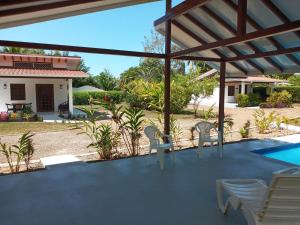 a view of a patio with chairs and a pool at Casa Hibiscus in Ojochal