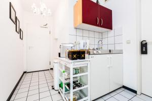 a small kitchen with white cabinets and a sink at MY Messe & Business Home - by Lanxess Arena /Messe Cologne in Cologne