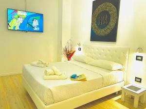 a bedroom with a large bed with towels on it at Hotel Okinawa in Rimini