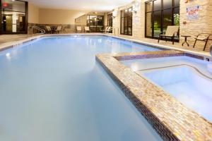 a swimming pool with blue water in a hotel at Holiday Inn San Antonio North Stone Oak Area, an IHG Hotel in San Antonio