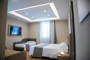 Säng eller sängar i ett rum på Hotel Ristorante Aeclanum