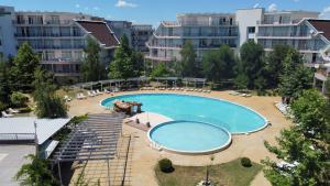 a large swimming pool in a city with buildings at Yves 2 Bed apart at Sun Village Sunny Beach not far away from the sea in Sunny Beach +32 photos