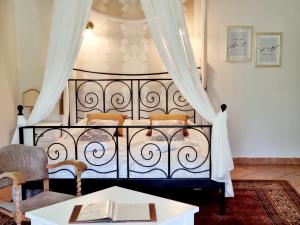 En eller flere senge i et værelse på Villa Toscana Boutique