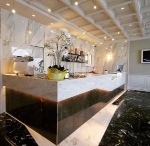 a large kitchen with a large counter with flowers on it at Hotel Ristorante Aeclanum in Mirabella Eclano