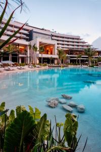 a large swimming pool in front of a building at Secrets Moxché Playa del Carmen - Adults Only - All Inclusive in Playa del Carmen