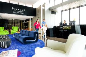 a group of people walking through a furniture store at Peppers Gallery Hotel in Canberra +150 photos