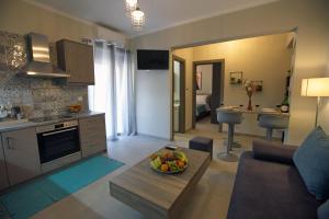 a kitchen and living room with a bowl of fruit on a table at Matoulas Luxury Apartment in Nafplio