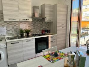 a kitchen with a sink and a stove top oven at Bnbook Olona-Fiera Milano in Pero