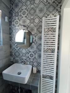 a bathroom with a sink and a mirror at Andi's Studio Porto Rafti in Porto Rafti
