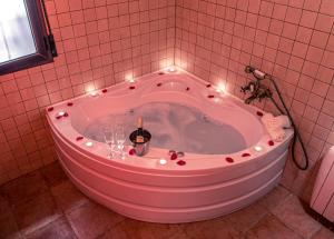 a bath tub with a bottle of wine in it at Casa Cueva Alegría in Valdeganga +41 photos