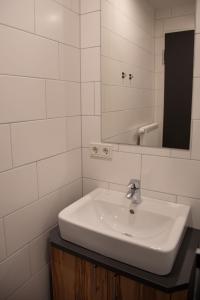 a white bathroom with a sink and a mirror at Gasthof zur Post in Lalling