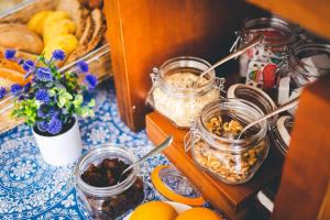 a table topped with jars of food on a table at Hotel Don Ignacio in San José