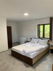 a bedroom with a large bed with white sheets and pillows at Casa Steluta de Mare in 2 Mai