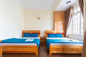 Postel nebo postele na pokoji v ubytování Gia Pham Hotel