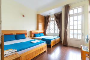 Postel nebo postele na pokoji v ubytování Gia Pham Hotel