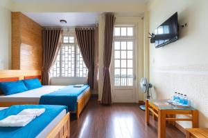 Postel nebo postele na pokoji v ubytování Gia Pham Hotel