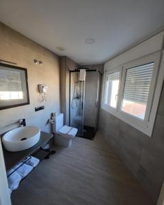 a bathroom with a sink and a toilet and a shower at HOSTAL HABITAT MUXIA II in Muxia