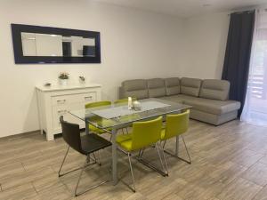 a living room with a table and chairs and a couch at Yacht Club Apartamenty in Radzyń