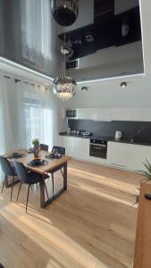 a kitchen with a wooden table and a dining room at Haven Apart Karpacz in Karpacz