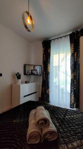 a bedroom with a bed and a tv and curtains at Haven Apart Karpacz in Karpacz