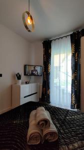 a bedroom with a bed and a tv and curtains at Haven Apart Karpacz in Karpacz +11 photos