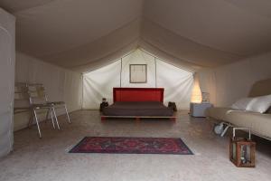 Postel nebo postele na pokoji v ubytování Glamping Agricampeggio Tognoni