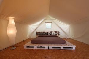 Postel nebo postele na pokoji v ubytování Glamping Agricampeggio Tognoni