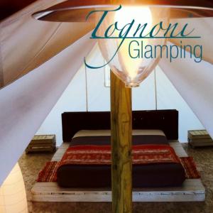 Postel nebo postele na pokoji v ubytování Glamping Agricampeggio Tognoni