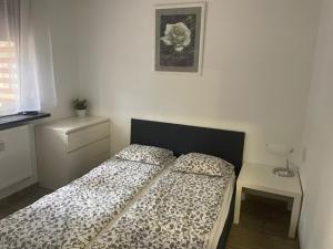 a bedroom with a bed with a black and white comforter at Yacht Club Apartamenty in Radzyń