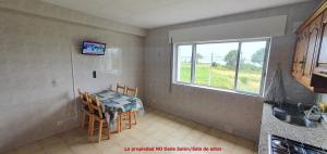 a small kitchen with a table and a window at Carnota PLAYA a 100 metros in Carnota