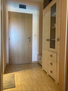 a room with a wooden door and a closet at Apart Hotel Aqua Dreams in Sveti Vlas