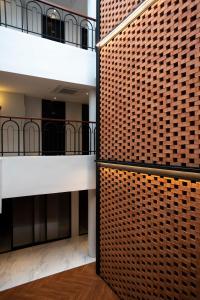 a building with two balconies and a brick wall at Monocolo Boutique Hotel in Kota Kinabalu