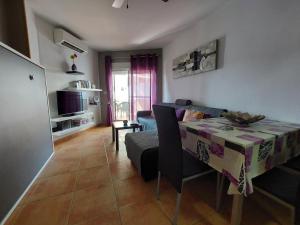 a living room with a table and a couch at Apartamento Sirena in Almuñécar