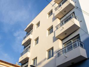 a building with balconies on the side of it at Puesta de Sol Rentals 3AJ in Playa de San Juan