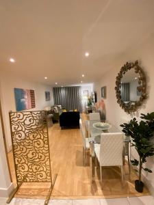 a dining room and living room with a table and chairs at Fabulous 2 bed apartment in Vauxhall in London