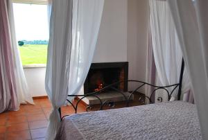 a bedroom with a bed with a fireplace and a window at LOCANDA FAZIO in Rome